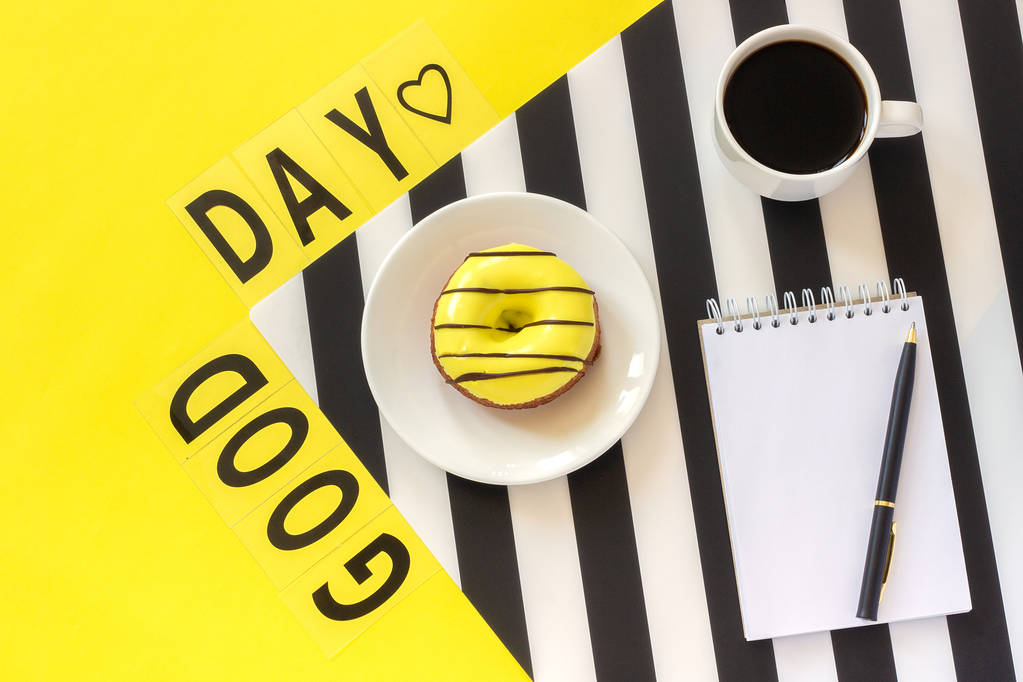 Text Good day Coffee, Donut, notepad on stylish black and white napkin on yellow background . Minimal style. Concept Flat lay Top view Copy space. - Photo, Image