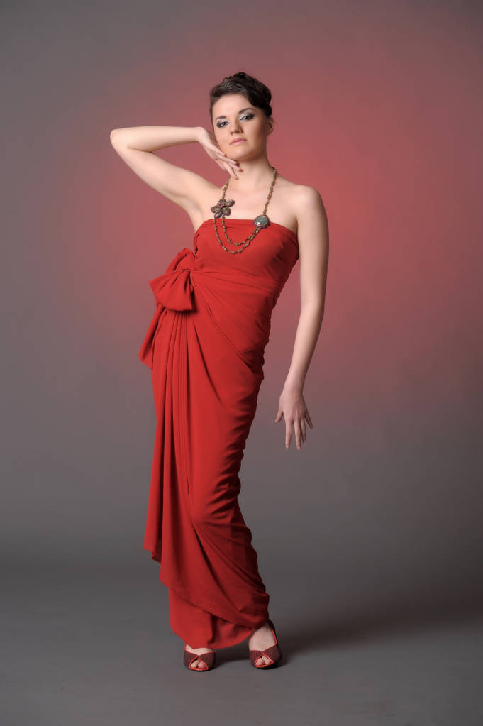 chica en un vestido largo rojo de pie
 - Foto, Imagen