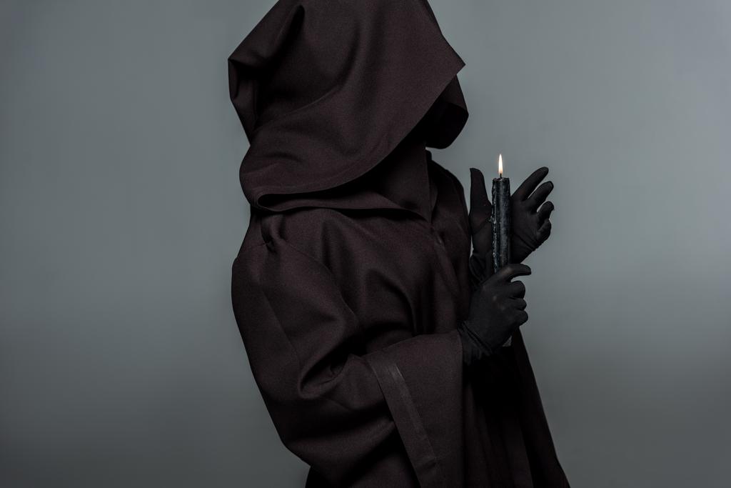 woman in death costume holding burning candle isolated on grey - Photo, Image