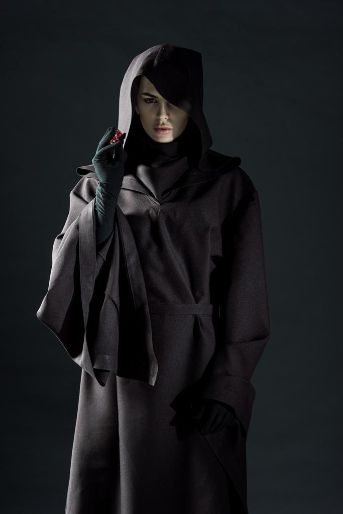 vista frontale della donna in costume da morte con dadi isolati sul nero
 - Foto, immagini