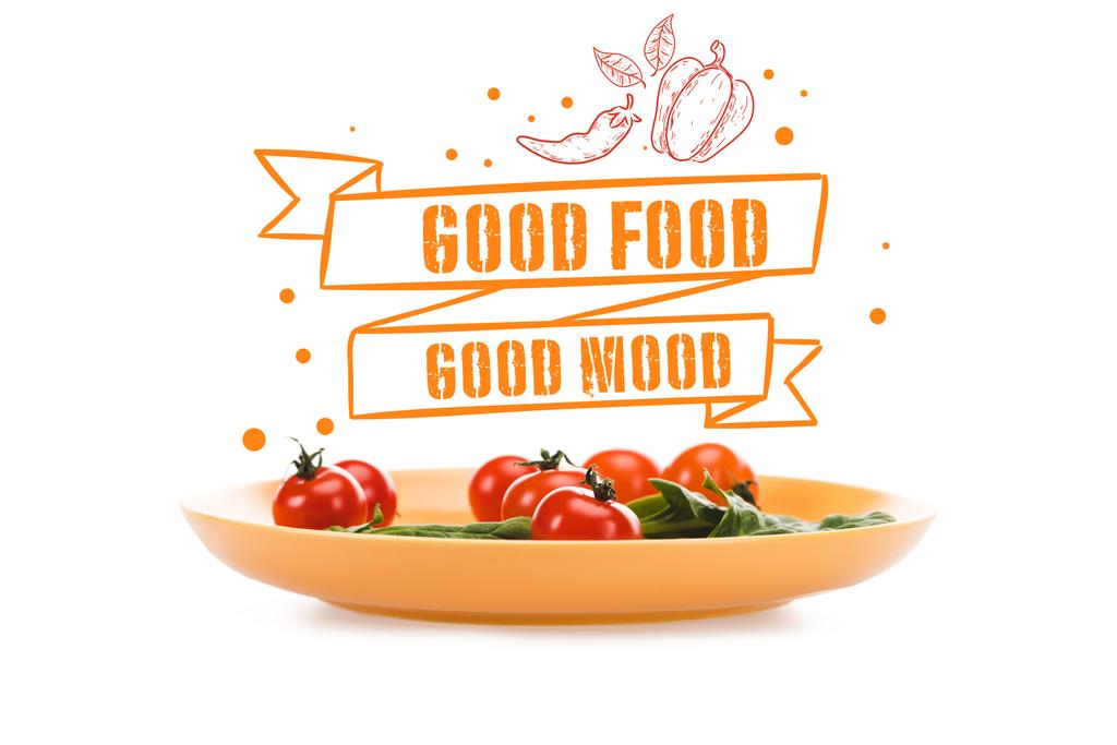 tomates cherry con hojas de espinaca verde en plato amarillo con buena comida letras de buen humor por encima aislado en blanco
 - Foto, Imagen