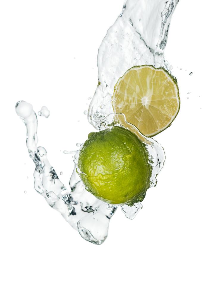 limão inteiro fresco verde e metade com fluxo de água clara e gotas isoladas em branco
 - Foto, Imagem
