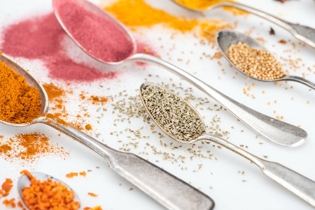 close up view of various aroma spices in silver spoons on white background - Photo, Image