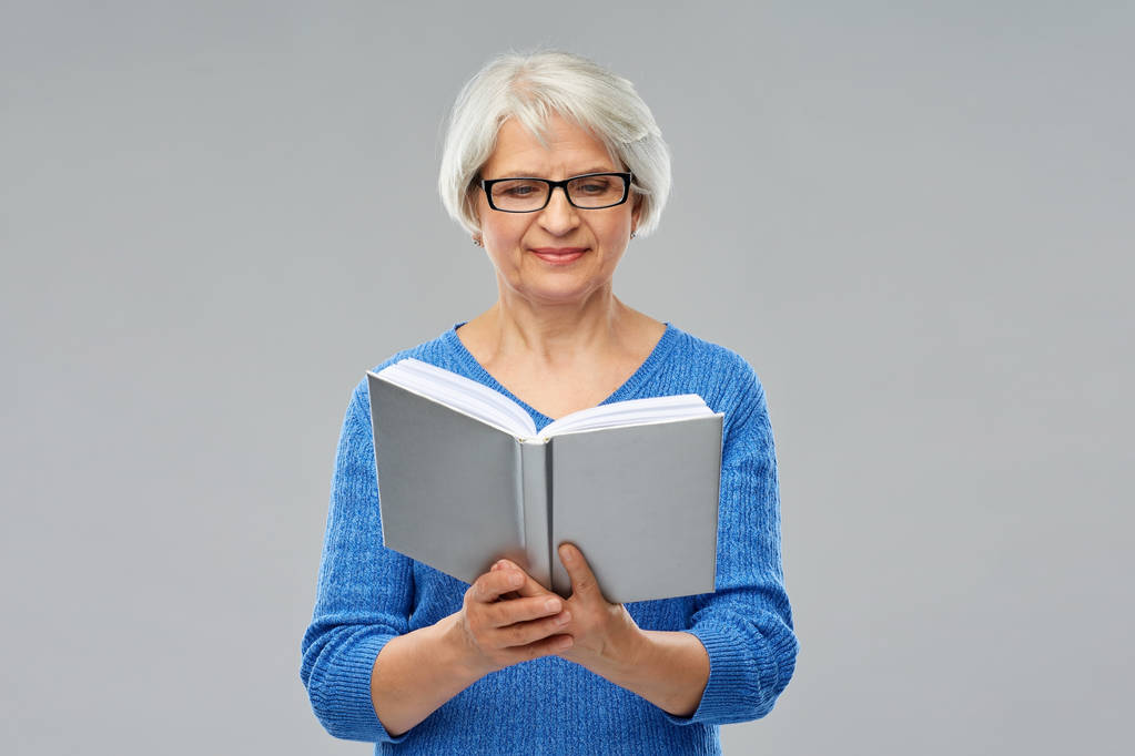 senior femme dans lunettes livre de lecture - Photo, image