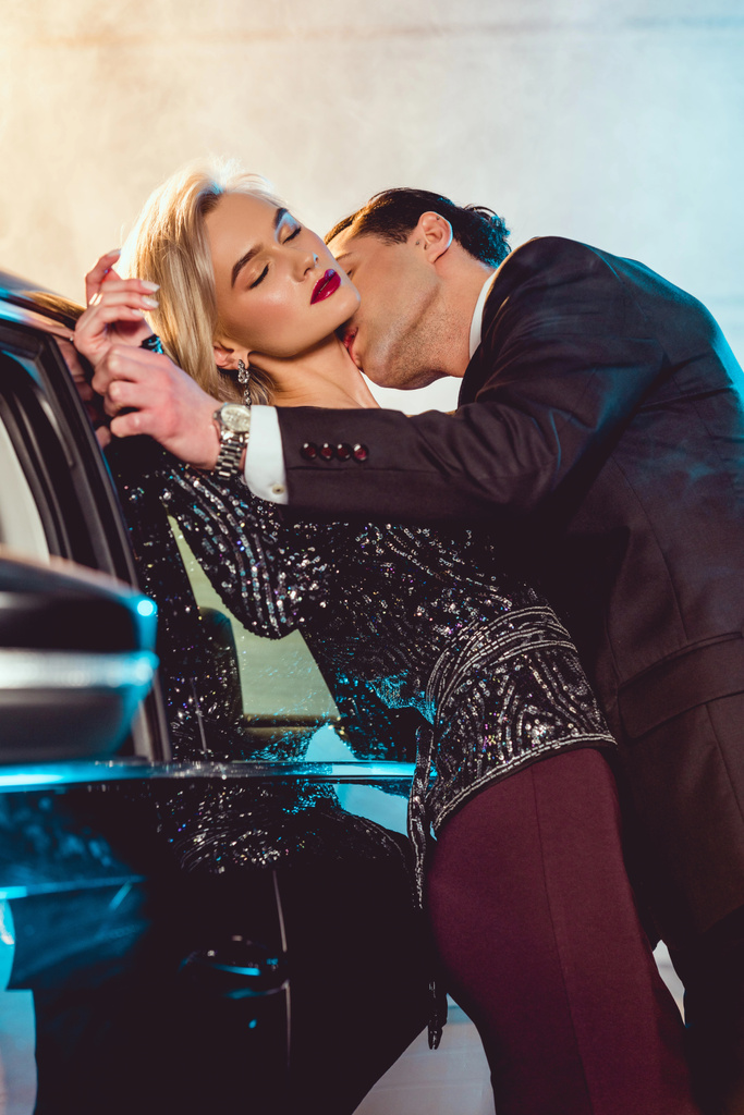 stylish man kissing beautiful sensual woman near car - Photo, Image