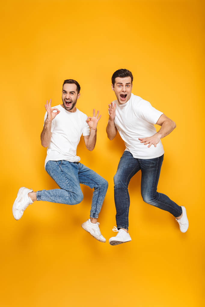 Full length of two cheerful excited men friends - Photo, Image