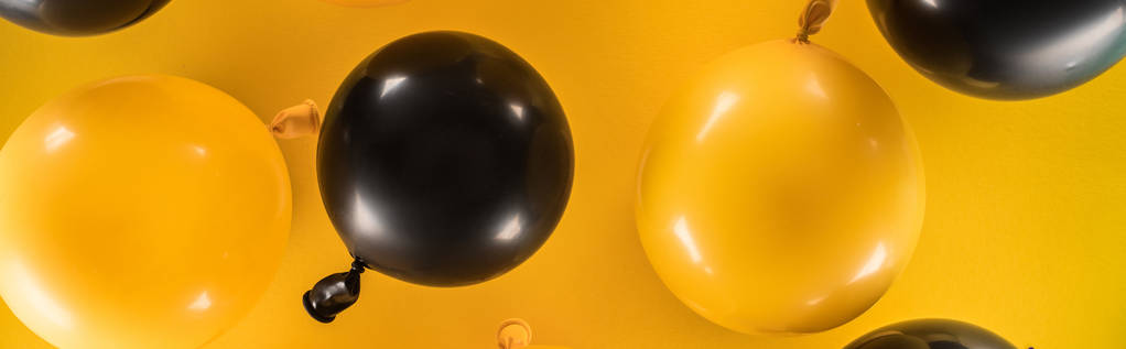 Foto panorámica de globos amarillos y negros sobre fondo brillante
 - Foto, imagen