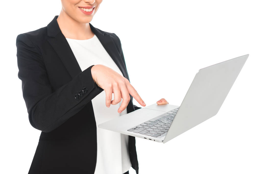 частичный вид улыбающейся смешанной расы деловая женщина с помощью ноутбука изолированы на белом
 - Фото, изображение