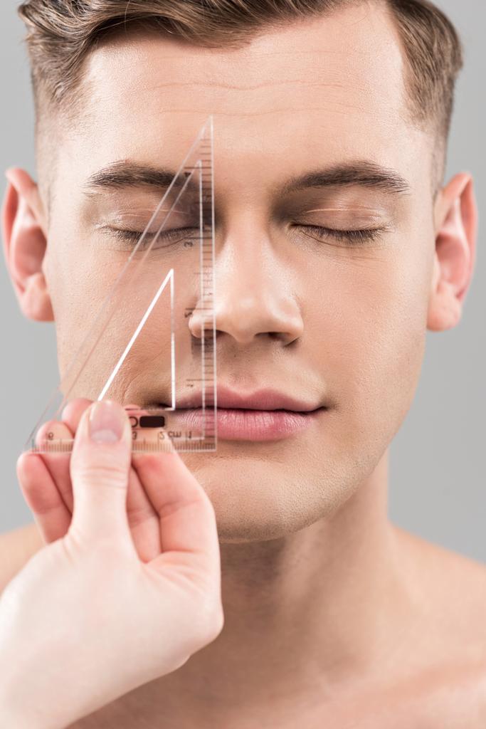 cropped view of plastic surgeon measuring face with ruler isolated on grey - Photo, Image