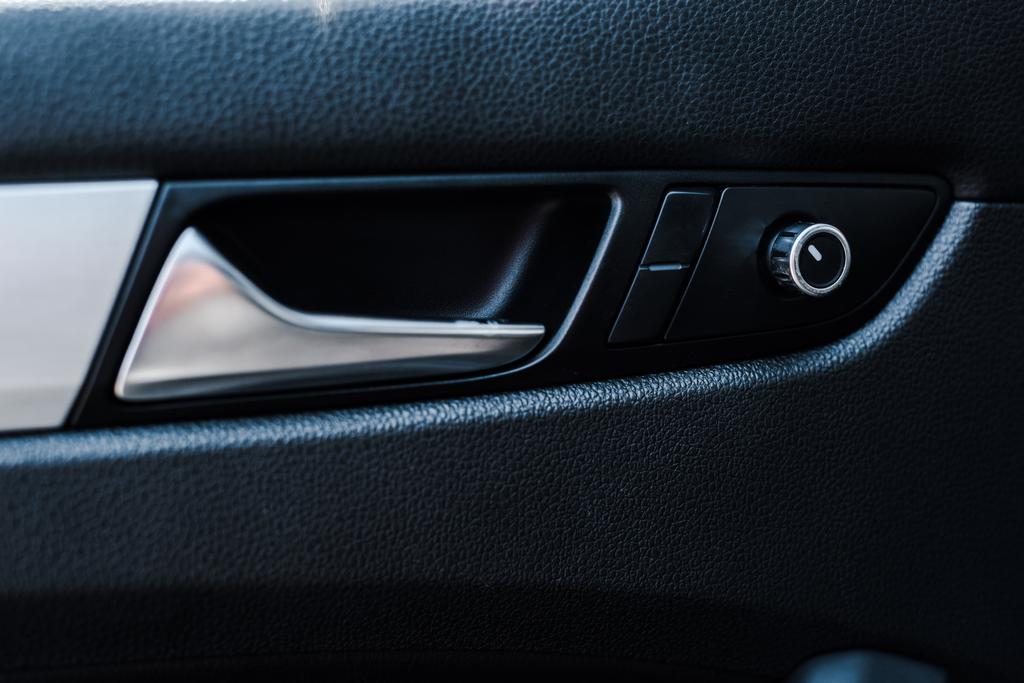 metallic automobile door handle near buttons in modern car  - Photo, Image