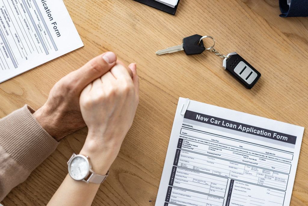 cropped view of man and woman holding hands near car key and documents  - Photo, Image