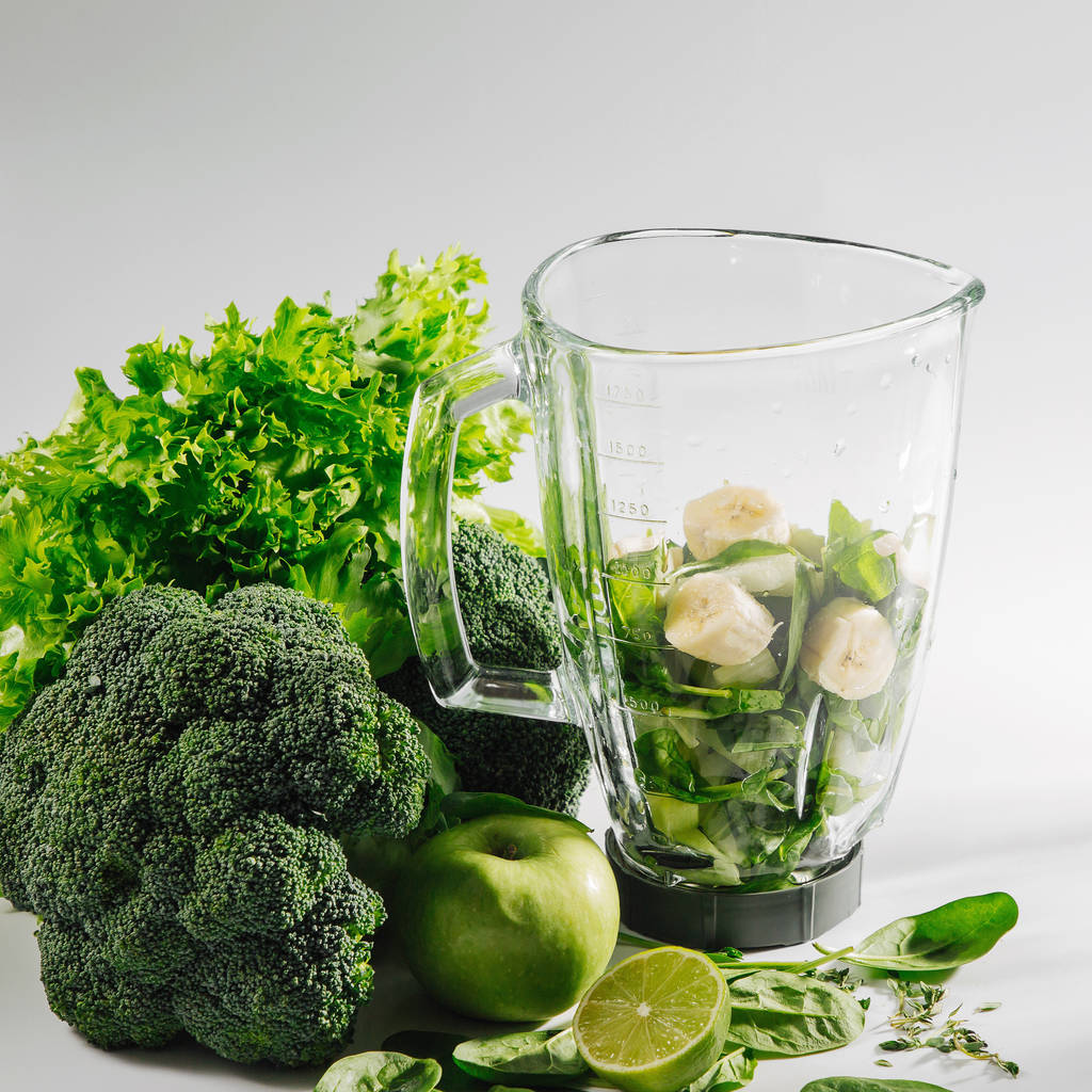 Υλικά για πράσινα smoothies στο μπλέντερ. Υγιεινή διατροφή με σπανάκι και πράσινα λαχανικά. Χορτοφαγικά τρόφιμα. - Φωτογραφία, εικόνα