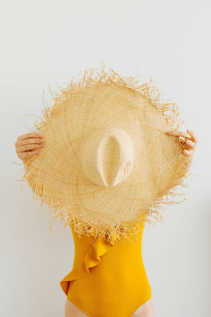 Female hands hold  Summer straw hat. Vacation concept - Photo, Image