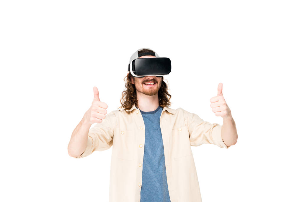 young man using VR headset showing thumb up at camera isolated on white - Photo, Image