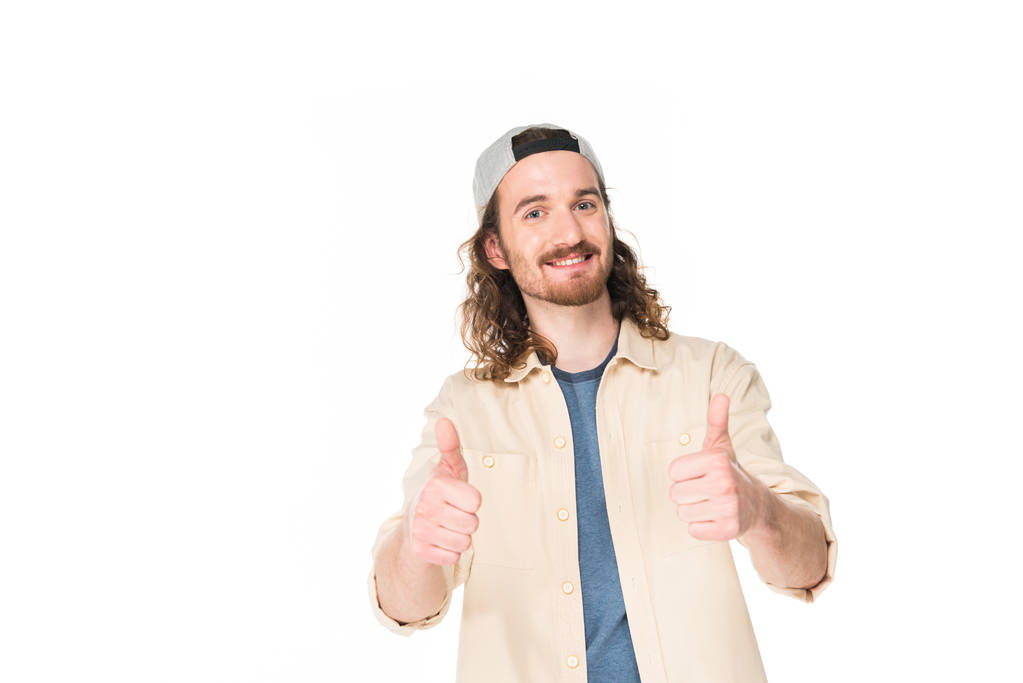 handsome young man showing thumbs up at camera isolated on white - Photo, Image