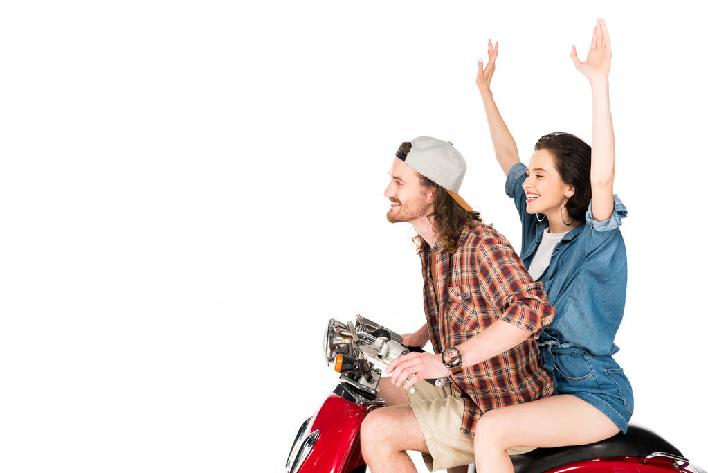 side view of girl with hands in air and young man sitting on red scooter isolated on white - Photo, Image