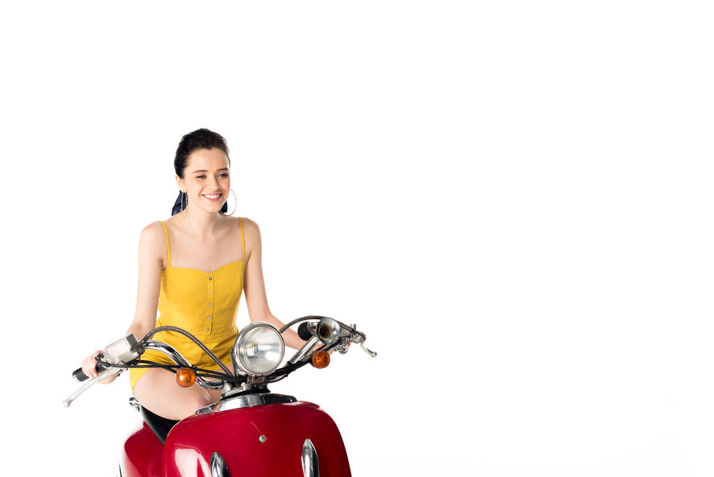 beautiful girl sitting on red scooter and smiling isolated on white - Photo, Image