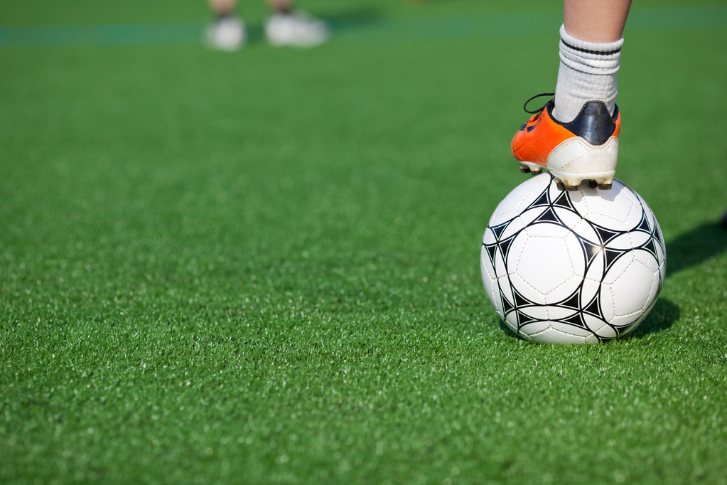 Chlapcova noha na fotbalový míč v poli - Fotografie, Obrázek