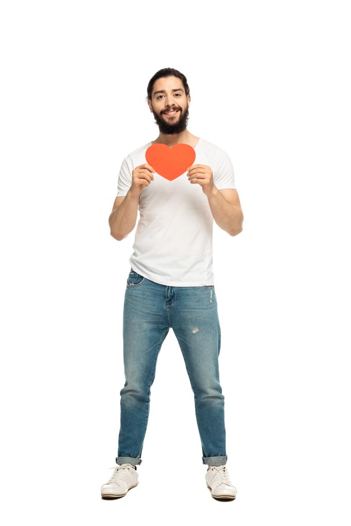 bearded latin man holding red heart-shape carton and smiling isolated on white  - Photo, Image