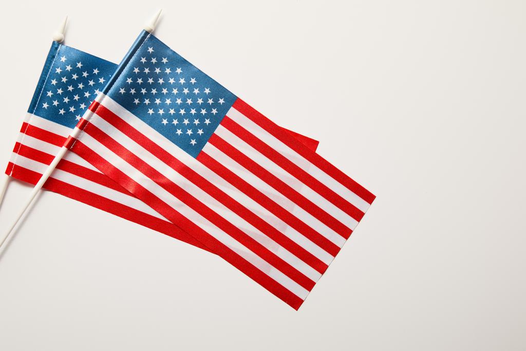 vista superior de banderas americanas sobre palos sobre fondo blanco
  - Foto, Imagen