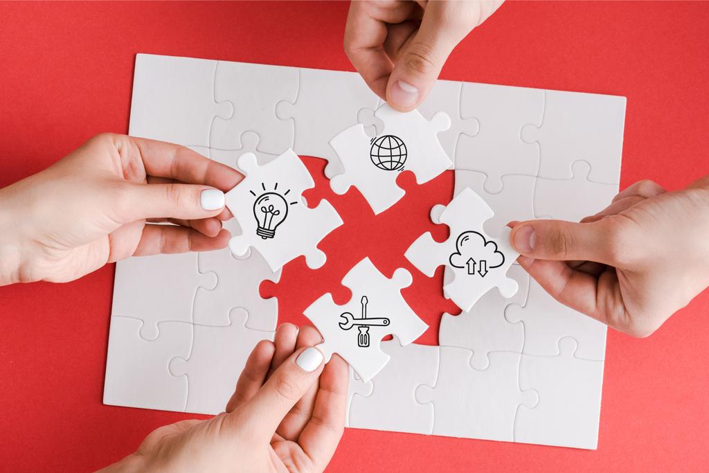 top view of man and woman holding white puzzle pieces with illustration on white  - Photo, Image