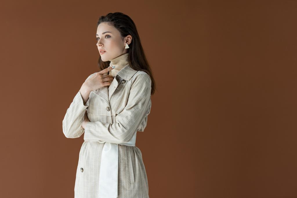 fashionable woman in trench coat isolated on brown with copy space  - Photo, Image
