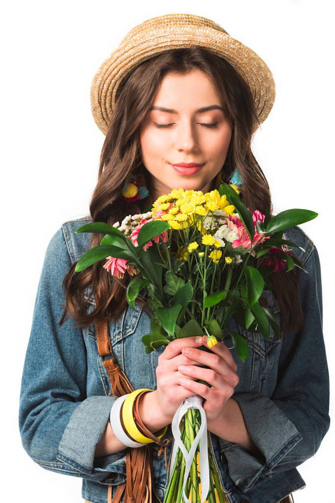 happy boho girl in straw hat holding flowers with closed eyes isolated on white - Photo, Image