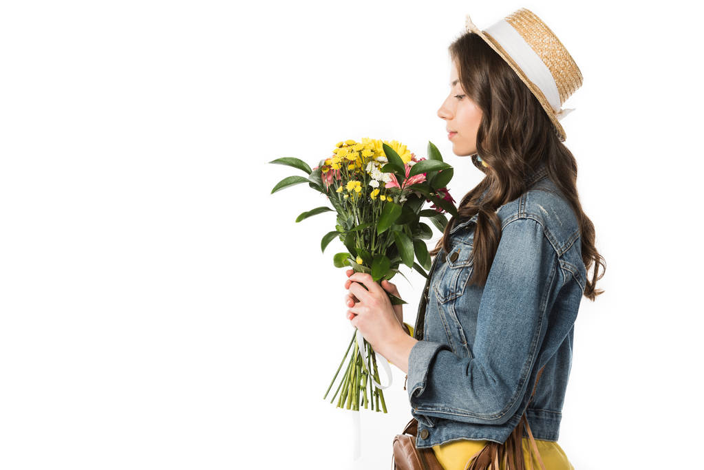 side view of boho girl in straw hat holding flowers isolated on white - Photo, Image