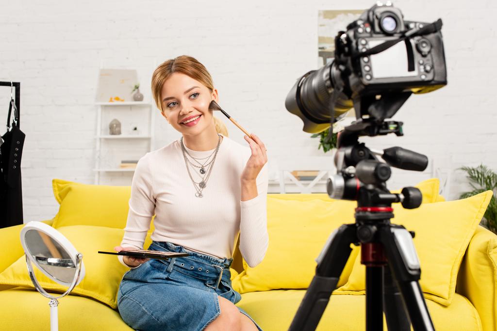 beauty blogger doing makeup in front of video camera at home - Photo, Image