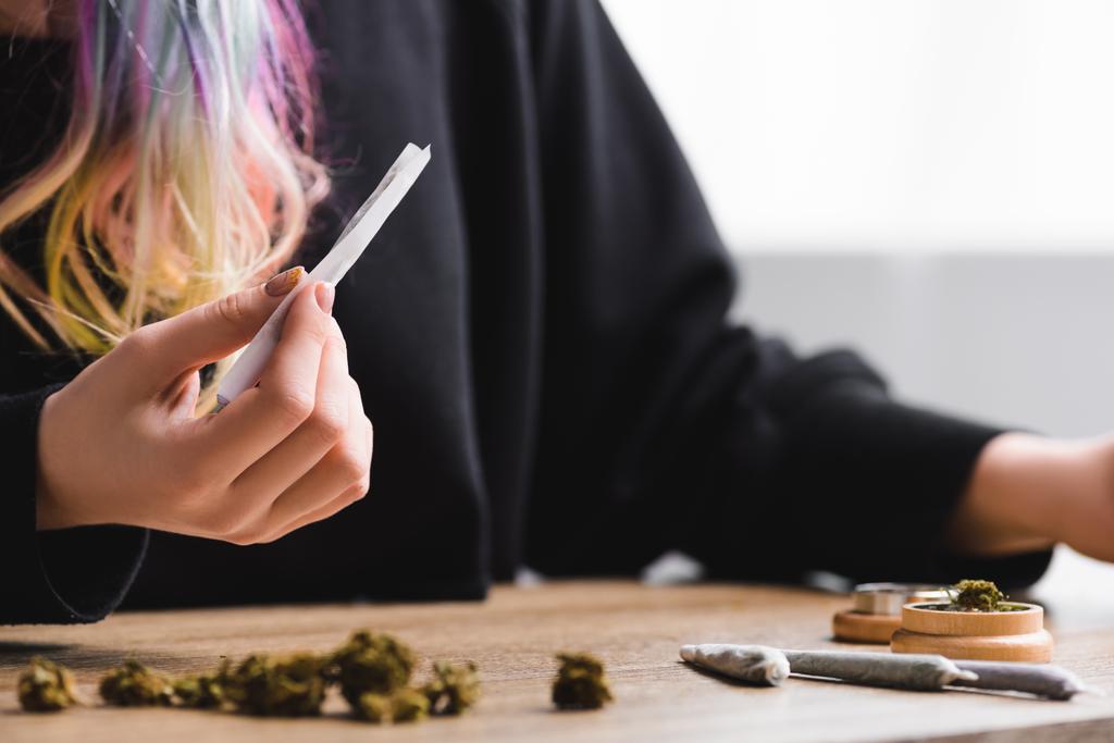 selective focus of girl holding joint with marijuana - Photo, Image
