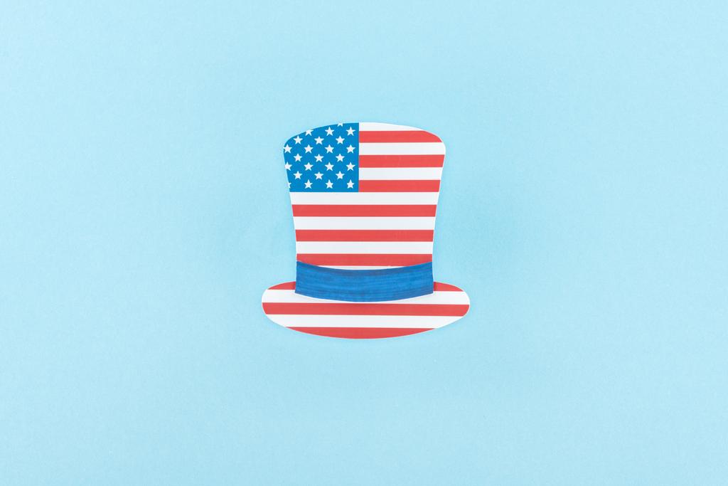 Widok z góry z papieru ozdobnego kapelusz wykonany z amerykańskiej flagi na niebieskim tle  - Zdjęcie, obraz