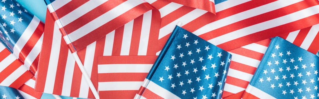 panoramic shot of american flags stacked on blue background - Photo, Image