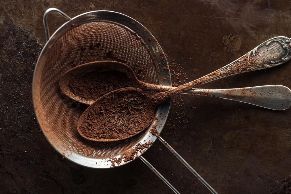 Top view of dirty strainer and vintage spoons on rust metal background - Photo, Image