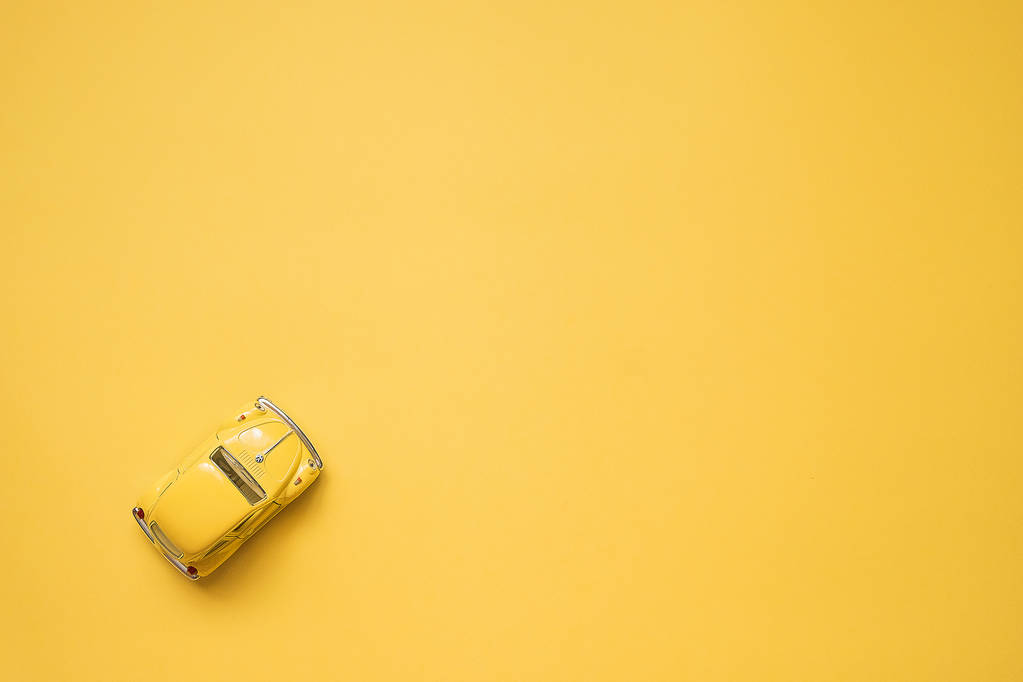 Omsk, Russia - May 26, 2019: Yellow retro toy car on yellow back - Zdjęcie, obraz