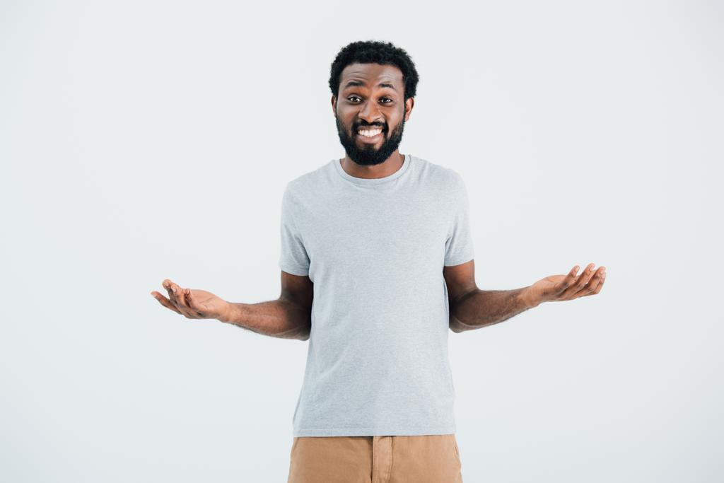african american man in grey t-shirt with shrug gesture isolated on grey - Photo, Image