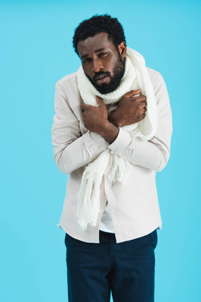 african american man in warm scarf having cold, isolated on blue - Photo, Image