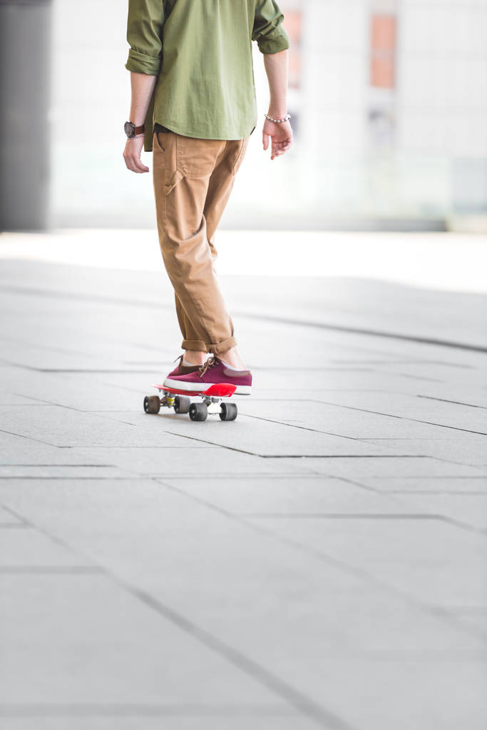 cropped view of man riding on penny board - Photo, Image