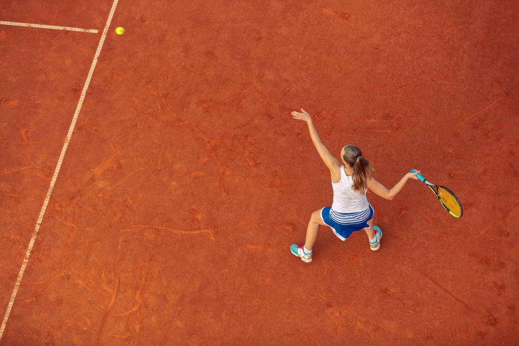 試合中にコート上の女子テニス選手の空中ショット。テニスをしている若い女性。高角ビュー. - 写真・画像