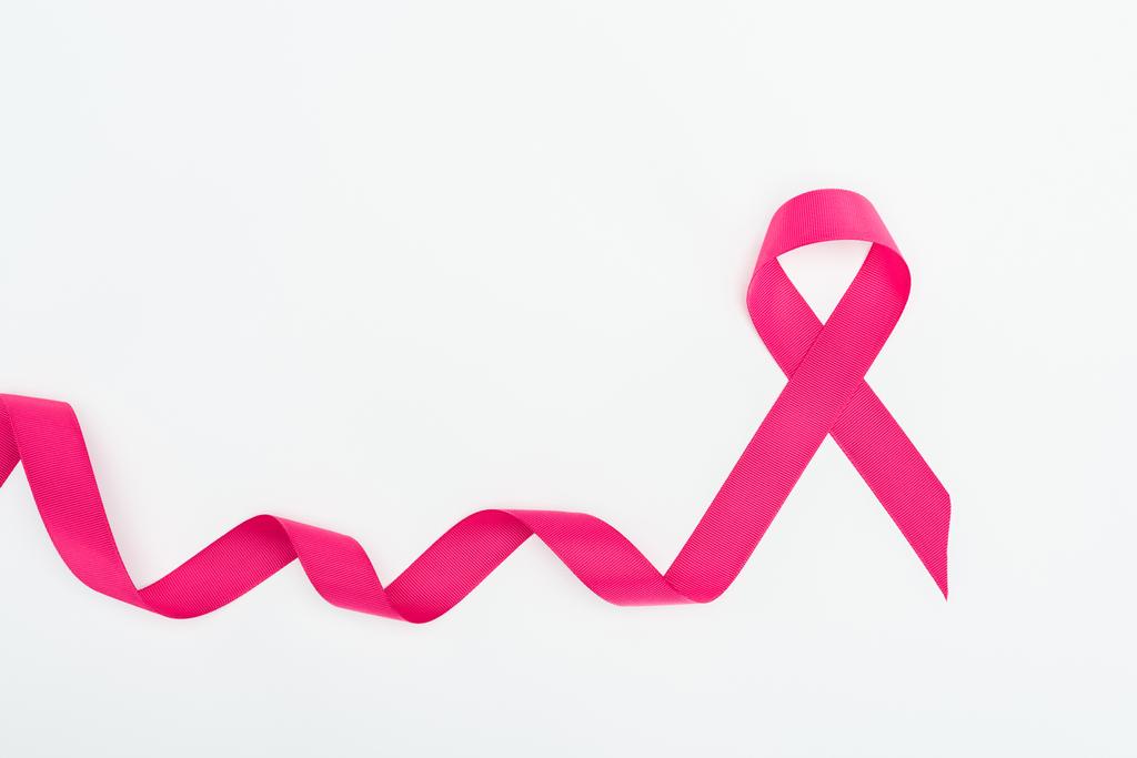 top view of curved crimson breast cancer ribbon on white background - Photo, Image