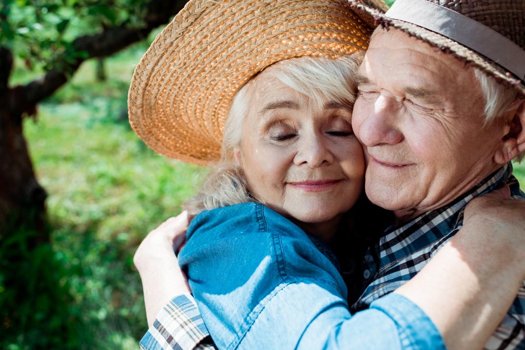 cheerful senior woman hugging happy retired husband with closed eyes - Photo, Image