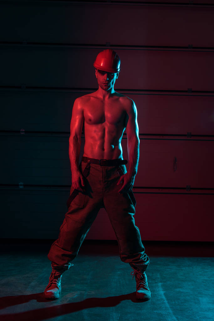 full length view of sexy shirtless fireman in darkness - Photo, Image