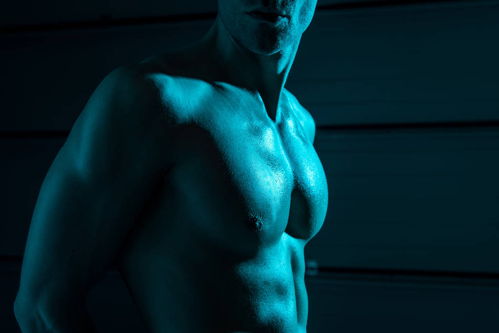 cropped view of sexy shirtless muscular man in darkness - Photo, Image