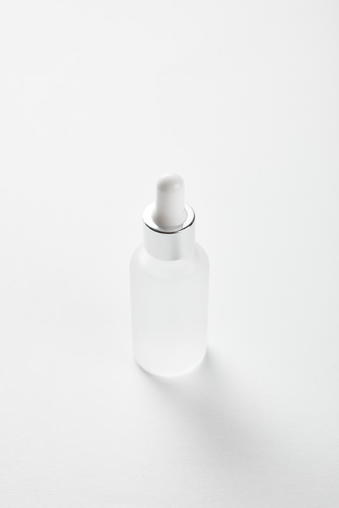 косметическая стеклянная бутылка с сывороткой на белом
  - Фото, изображение