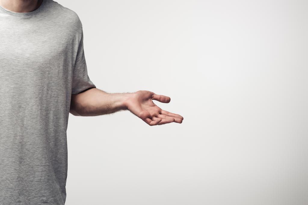cropped view of man showing shrug gesture isolated on grey, human emotion and expression concept - Photo, Image