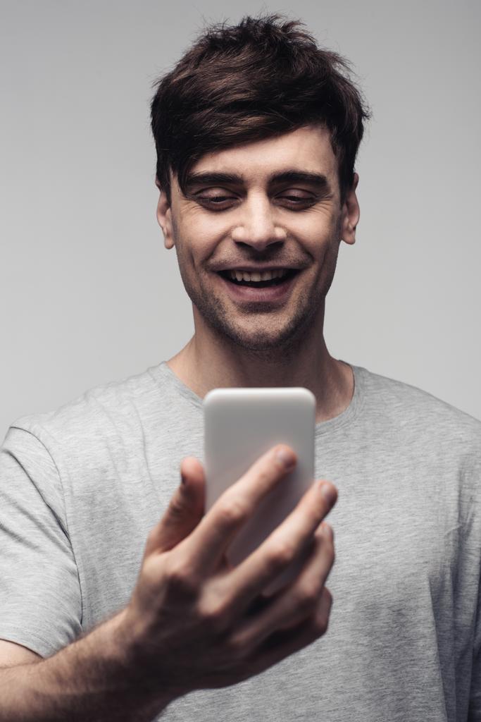 cheerful man having video call on smartphone isolated on grey - Photo, Image