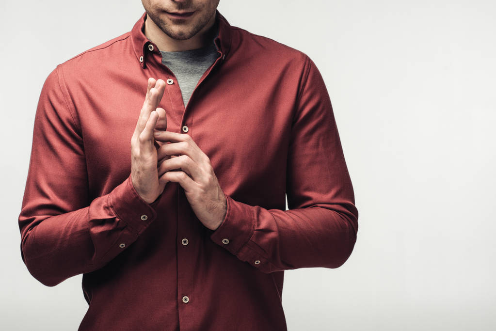 cropped shot of man in brown shirt gesturing with hands isolated on grey, human emotion and expression concept - Photo, Image