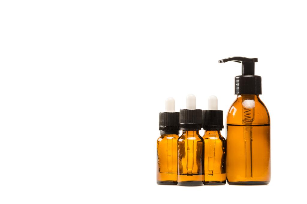bottles with serum and moisturizing cosmetics isolated on white  - Photo, Image