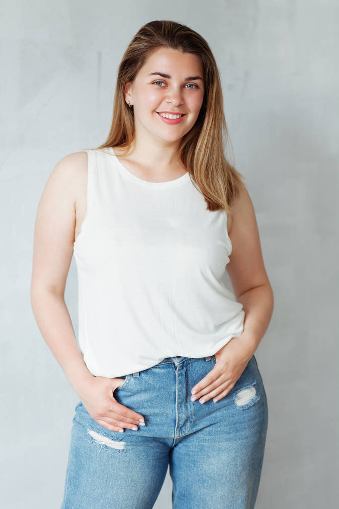 Young beautiful woman in white shirt and jeans  - Photo, Image