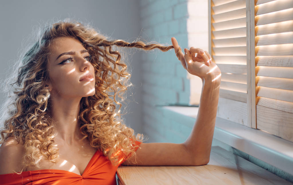 Shiny curly hair . Beautiful model woman with wavy hairstyle. Pretty woman with curly hair. - Photo, Image