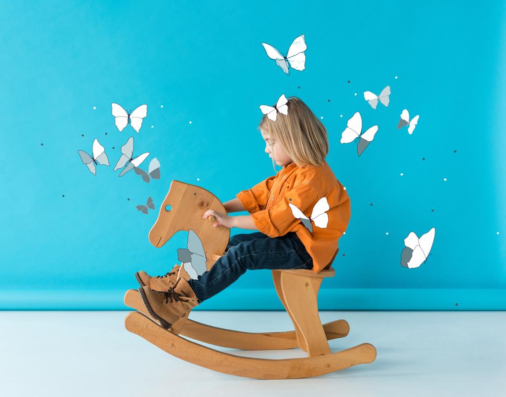 dziecko w dżinsy i pomarańczowa koszula jazda konna na niebieskim tle z bajki motyle ilustracja - Zdjęcie, obraz